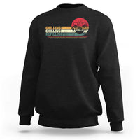 Black sweatshirt with front grill-themed text and smoker graphic.