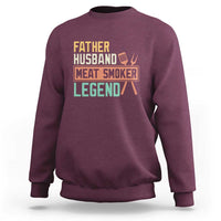 Men's maroon crewneck sweatshirt with 'Meat Smoker' retro graphic on chest