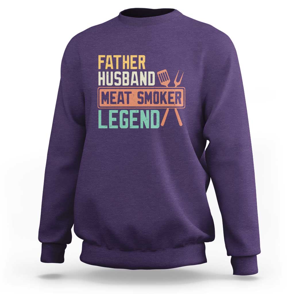 Men's purple crewneck sweatshirt with 'Meat Smoker' retro graphic on chest