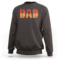 Dark brown crewneck dad BBQ grill sweatshirt with orange 'DAD' graphic