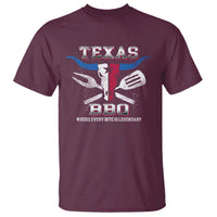 Maroon graphic T-shirt with Texas BBQ emblem and slogan on chest