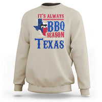 Sand crewneck sweatshirt with colorful Texas BBQ Season graphic on back.