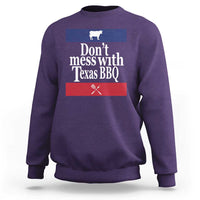 Purple BBQ sweatshirt with chest graphic reading “Don’t mess with Texas BBQ”
