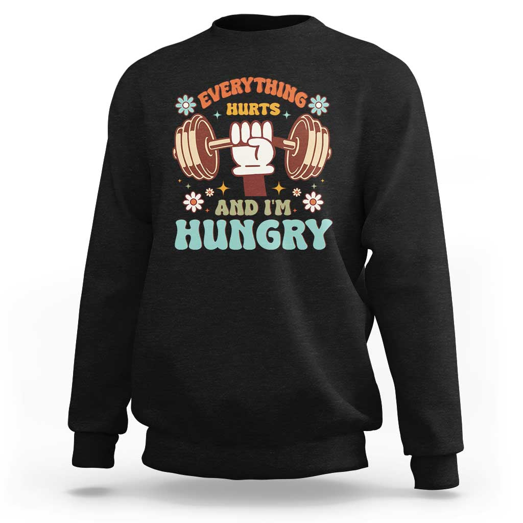 Black sweatshirt with "Everything Hurts and I'm Hungry" dumbbell graphic.