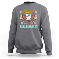 Charcoal gray sweatshirt with "Everything Hurts and I'm Hungry" dumbbell graphic.