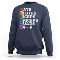 Navy crewneck sweatshirt with colorful “LATS GLUTES BICEPS TRICEPS QUADS” graphic
