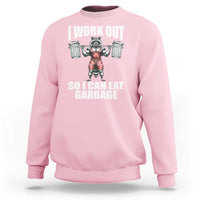 Light pink workout sweatshirt with front raccoon graphic and bold text print