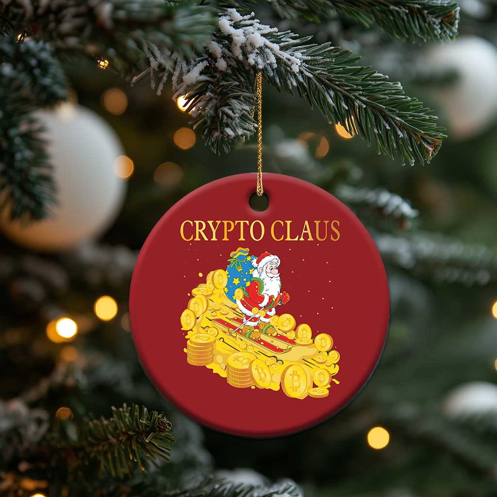 Red round 'CRYPTO CLAUS' ornament with Santa and gold coin sleigh, hanging from a tree branch