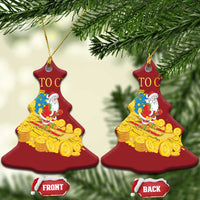 Pair of red bell ornaments with Santa beside a gold coin sleigh, partial 'TO' text visible