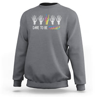 Charcoal crewneck sweatshirt with skeleton-hand rainbow graphic and "DARE TO BE YOURSELF"