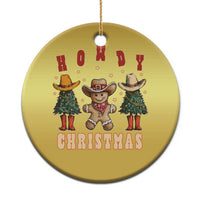 Gold round Howdy Christmas ornament with cowboy and cactus graphic, hanging gold string.