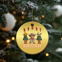 Gold round Howdy Christmas cowboy cactus ornament hanging from a gold string.