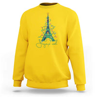 Yellow crewneck sweatshirt with Eiffel Tower Christmas tree graphic in multicolor