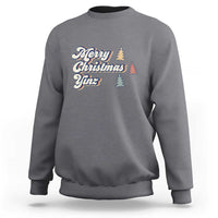 Charcoal gray crewneck sweatshirt with “Merry Christmas Yinz” holiday graphic and pine trees