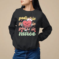Black pediatric nurse sweatshirt with cartoon nurse holding stethoscope graphic