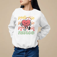 White pediatric nurse sweatshirt with cartoon nurse and stethoscope graphic