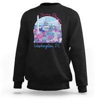 Black crewneck sweatshirt with colorful cherry blossom city graphic on chest