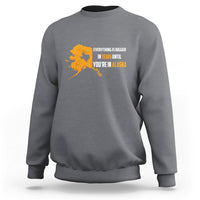 Charcoal gray crewneck sweatshirt with yellow map and text graphic on chest