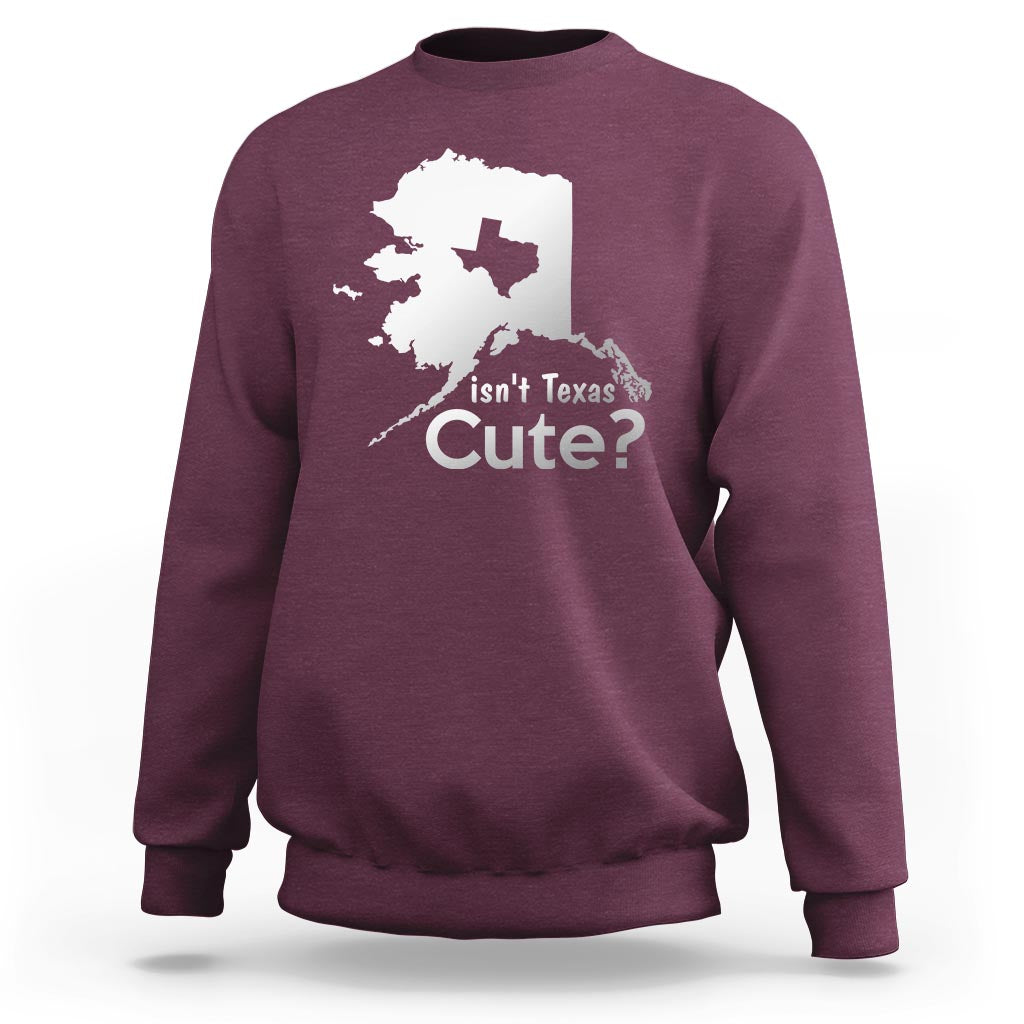 Maroon crewneck sweatshirt with white Alaska map graphic and text "Isn't Texas Cute?"