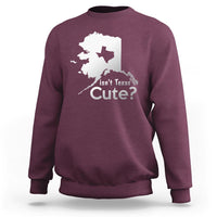 Maroon crewneck sweatshirt with white Alaska map graphic and text "Isn't Texas Cute?"