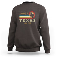 Dark brown crewneck sweatshirt with “Somebody Loves Me” Texas graphic on the chest