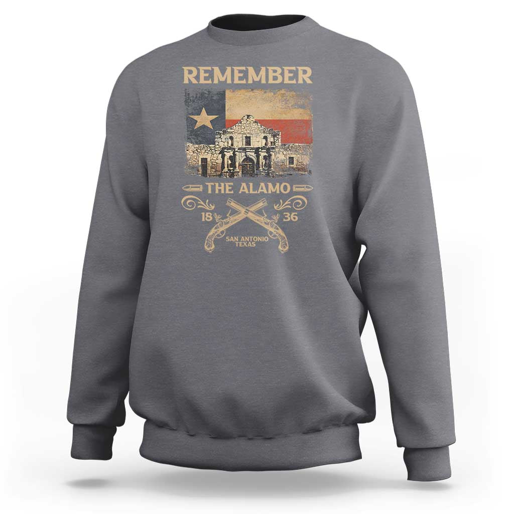Gray crewneck sweatshirt with 'Remember' Alamo graphic and stars-and-swords print.