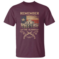 Men's maroon graphic T-shirt with Alamo flag artwork, 'Remember' lettering and crossed pistols