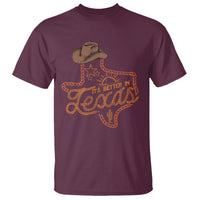 Maroon crewneck T-shirt with orange western Texas graphic of cowboy hat and boots