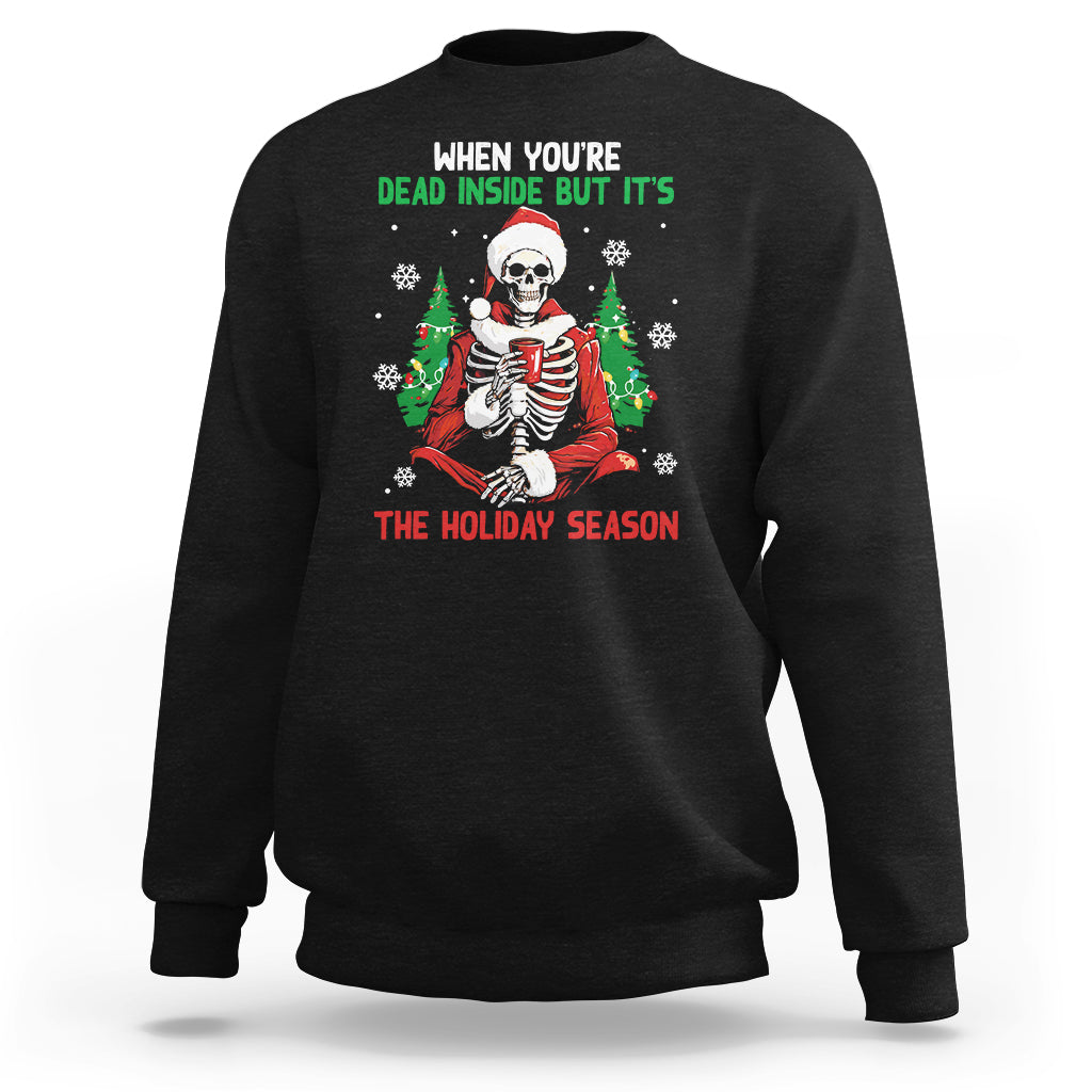 Black crewneck sweatshirt with cartoon skeleton in Santa hat and "THE HOLIDAY SEASON" print