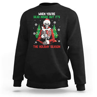 Black crewneck sweatshirt with cartoon skeleton in Santa hat and "THE HOLIDAY SEASON" print