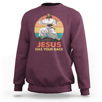 Maroon Christian sweatshirt with 'JESUS HAS YOUR BACK' graphic and seated figure