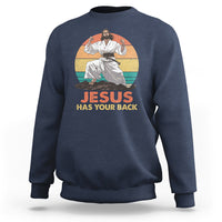 Navy Christian sweatshirt with 'JESUS HAS YOUR BACK' graphic and seated figure