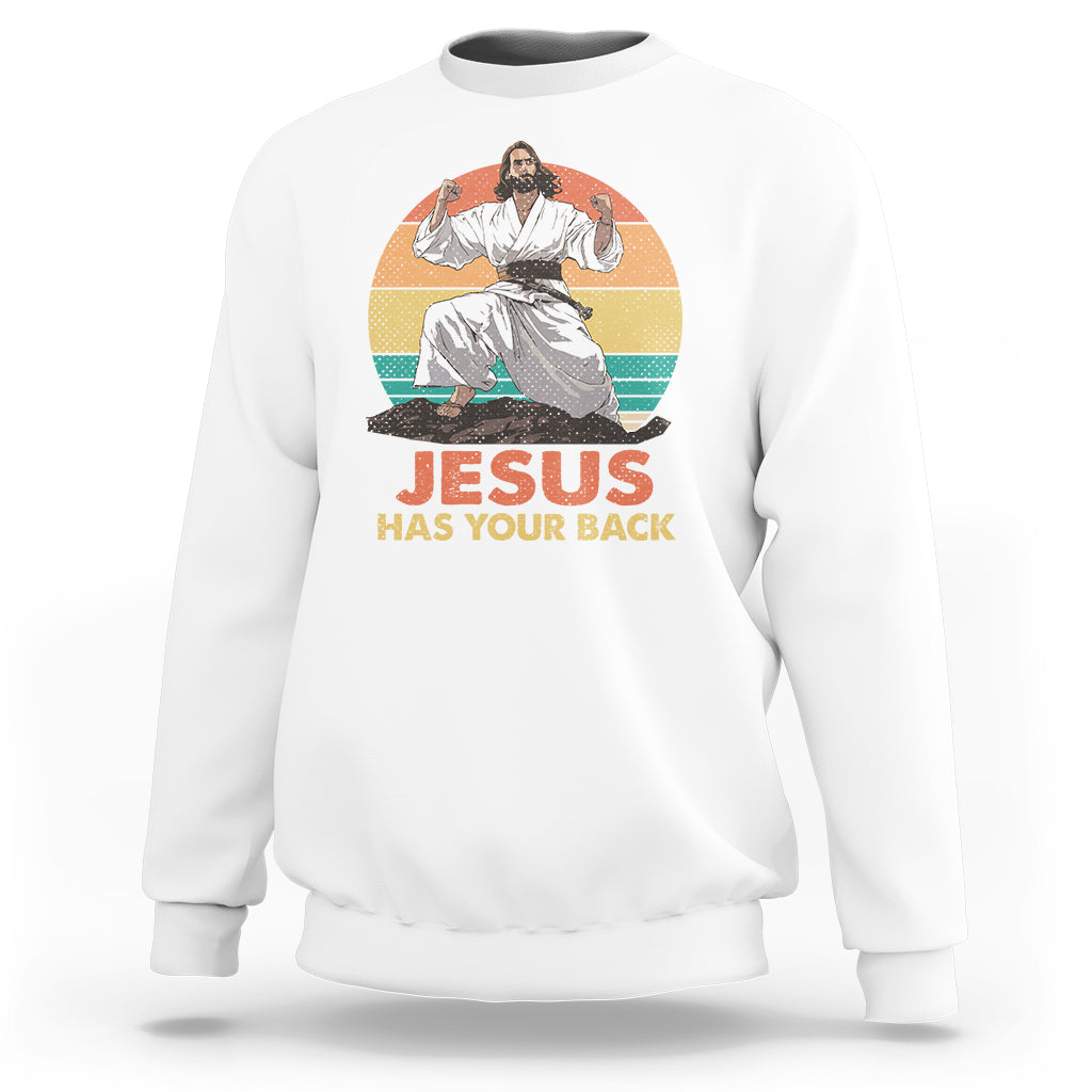 White Christian sweatshirt with 'JESUS HAS YOUR BACK' graphic and seated figure