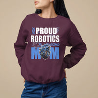 Maroon crewneck sweatshirt with “PROUD ROBOTICS MOM” text and robot heart graphic