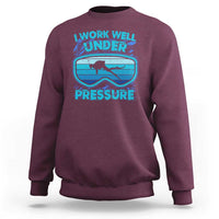 Maroon crewneck sweatshirt with scuba diving “Work Well Under Pressure” graphic