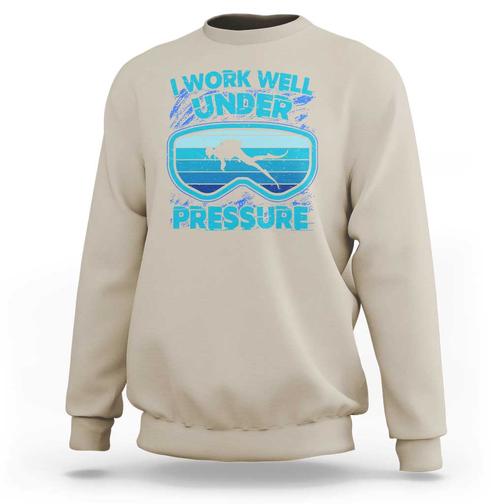 Sand beige crewneck sweatshirt with scuba diving “Work Well Under Pressure” graphic