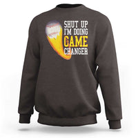 Charcoal baseball sweatshirt with graphic text “SHUT UP I’M DOING GAME CHANGER”