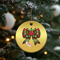 Gold circular Christmas bow ornament with red holly ribbons and “Merry Christmas”