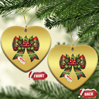 Gold heart-shaped Christmas bow ornaments with red holly ribbons and “Merry Christmas”