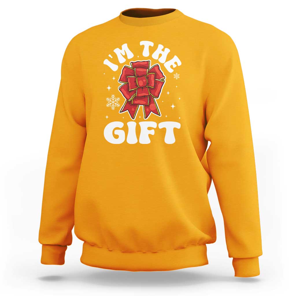 Gold unisex Christmas sweatshirt with 'I'm the gift' graphic and red bow illustration