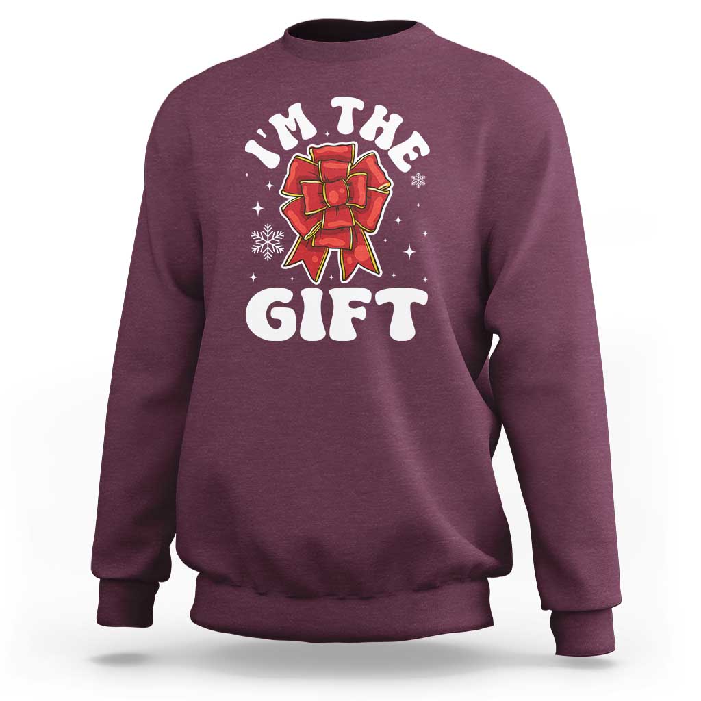 Maroon unisex Christmas sweatshirt with 'I'm the gift' graphic and red bow illustration