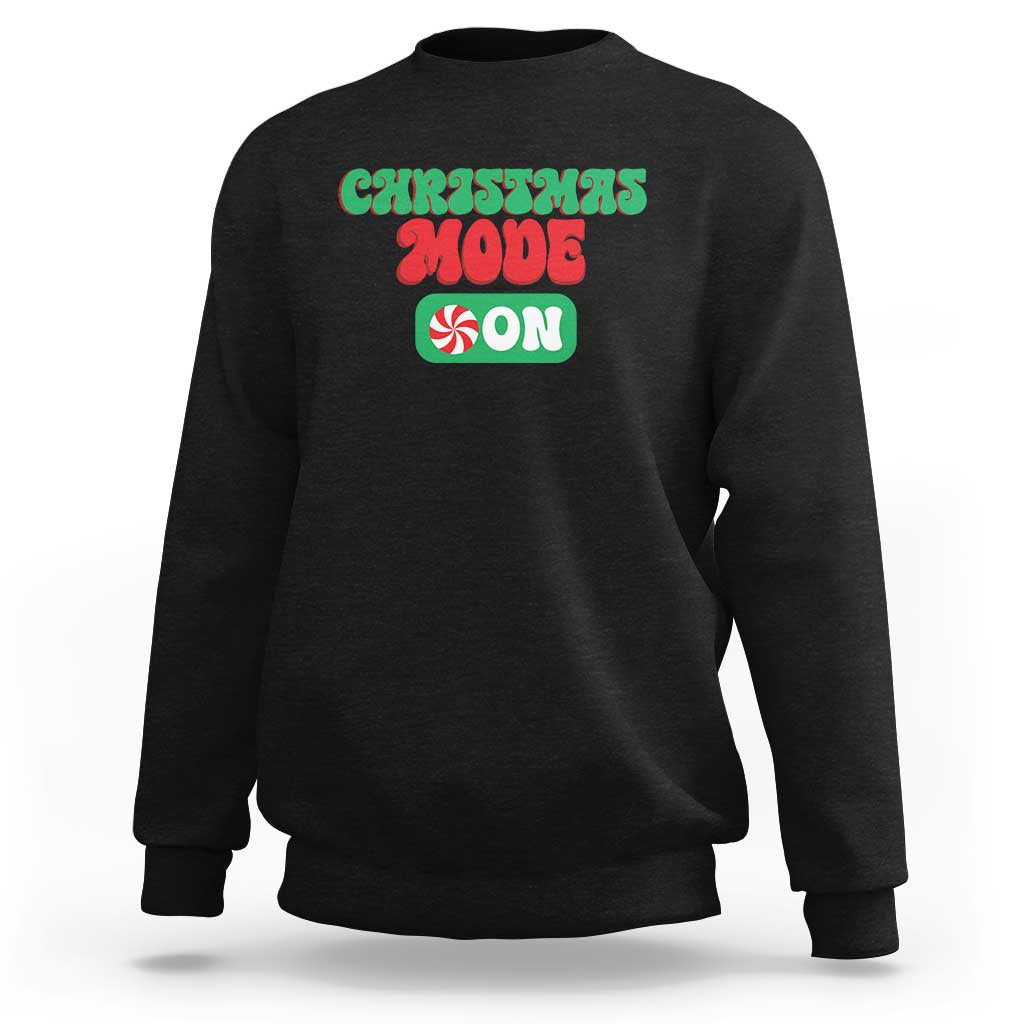 Black crewneck sweatshirt with front holiday graphic text, long sleeves