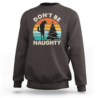 Dark chocolate crewneck sweatshirt with “DON’T BE NAUGHTY” graphic and dog silhouette