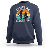 Navy crewneck sweatshirt with “DON’T BE NAUGHTY” graphic and dog silhouette