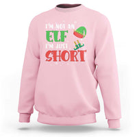 Light pink crewneck sweatshirt with elf graphic and text "I'm not an elf, I'm just short"