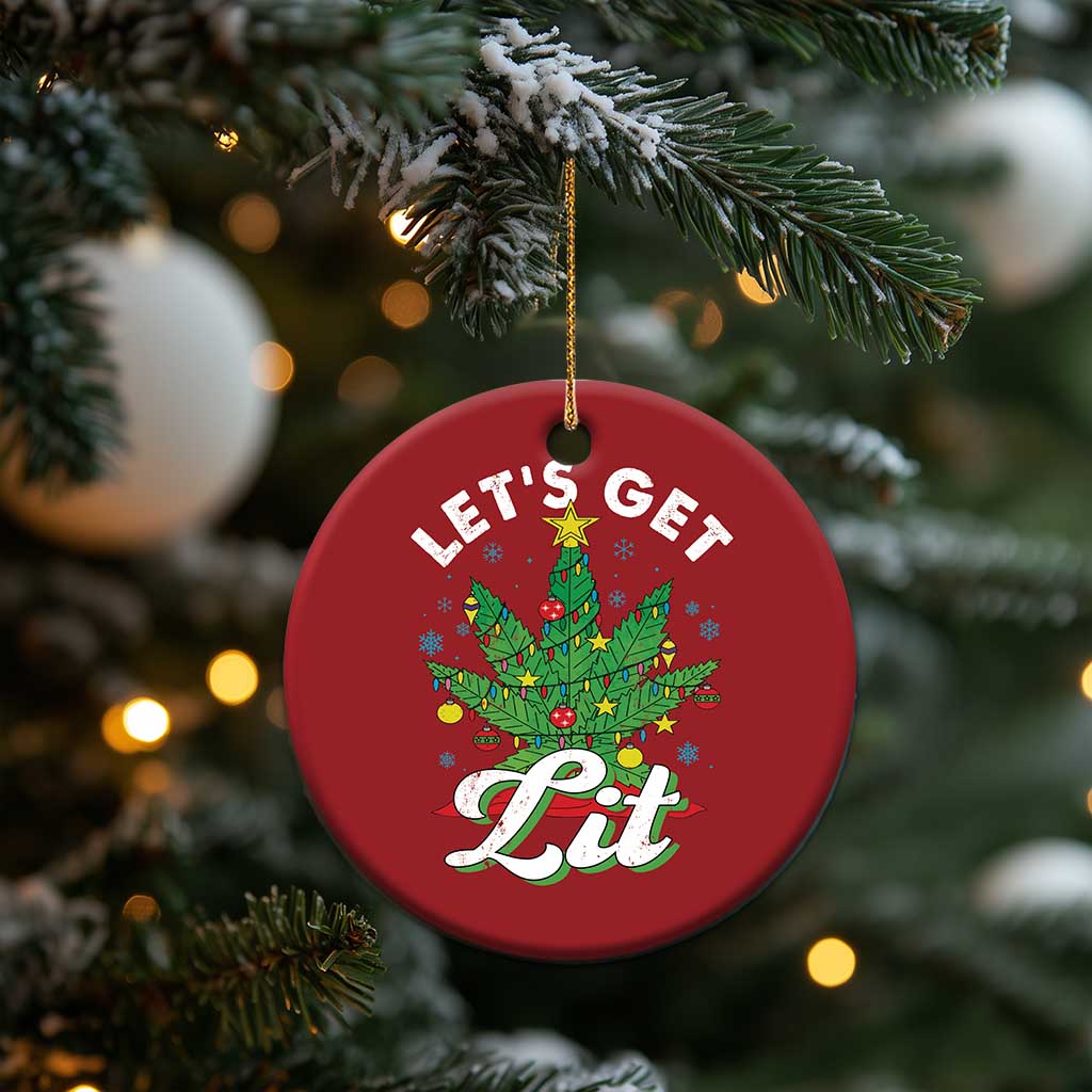 Red round 'Let's Get Lit' cannabis tree ornament hanging on a fir branch
