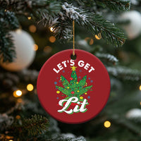 Red round 'Let's Get Lit' cannabis tree ornament hanging on a fir branch