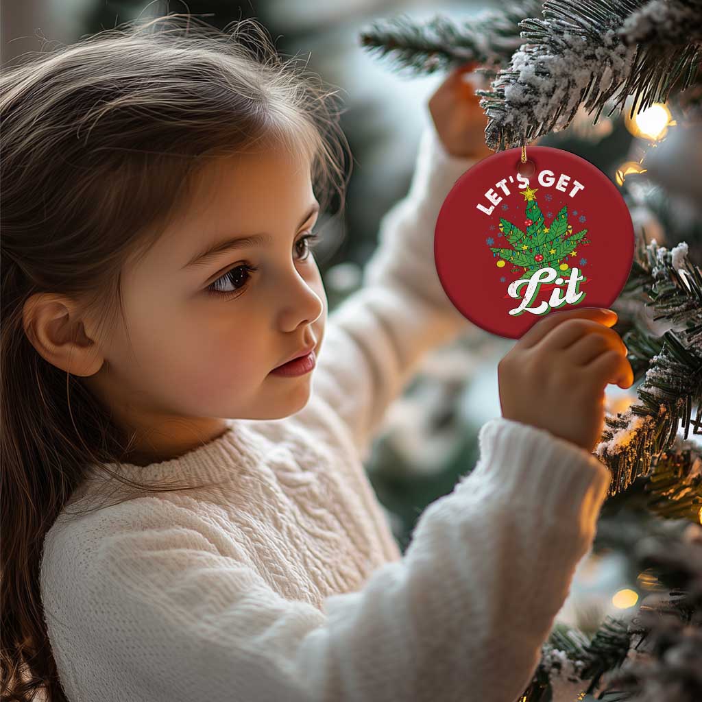 Red round 'Let's Get Lit' cannabis tree ornament near a child decorating a tree