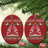 Pair of red oval Christmas ornaments with hanging gold loops and Christmas tree design