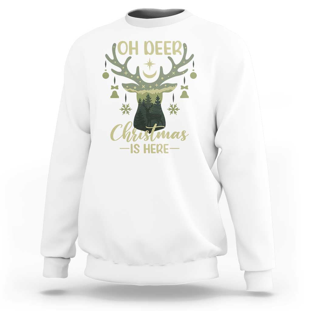 White crewneck sweatshirt with “OH DEER” antler graphic and “Christmas is Here” print
